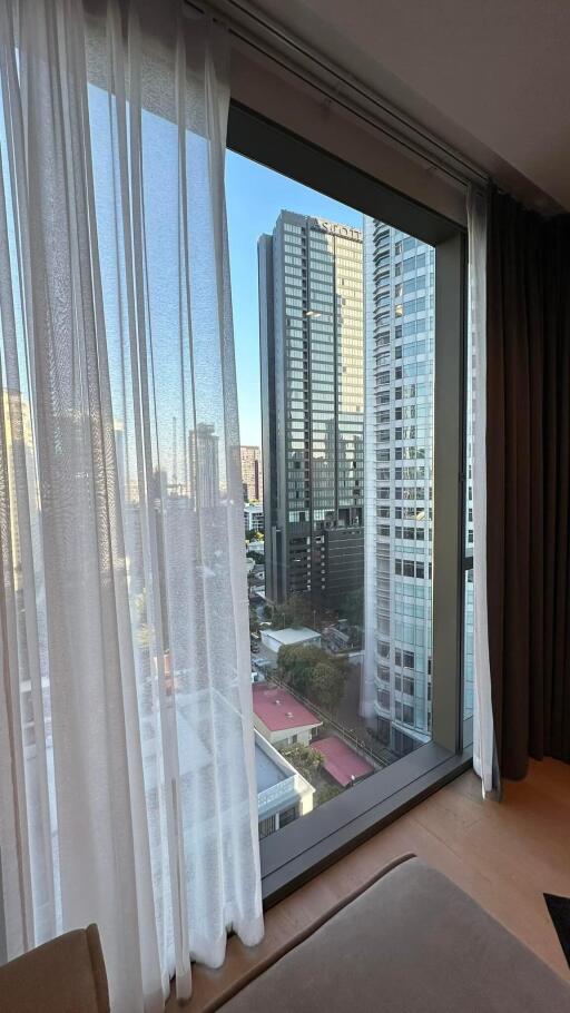 View from the living room showing cityscape through large window