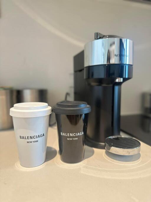 Luxury coffee setup with branded cups and modern coffee machine on counter