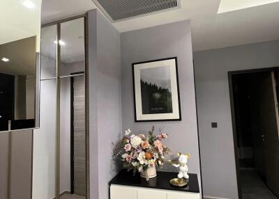 Modern hallway with mirror, cabinet, and decor