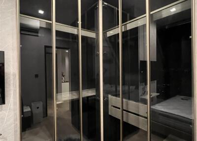 Glass-door wardrobe in bedroom