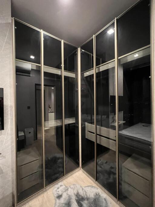 Glass-door wardrobe in bedroom