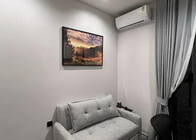 Compact living room with foldable sofa and air conditioning