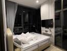 Modern bedroom with large window and night view