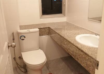 Modern bathroom with granite countertop and window