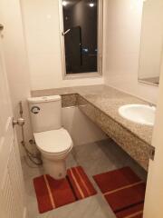 Modern bathroom with granite countertop and window