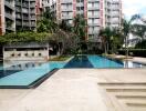 Outdoor pool area with surrounding apartments