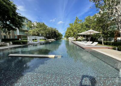 Outdoor pool area with lounge chairs and umbrellas