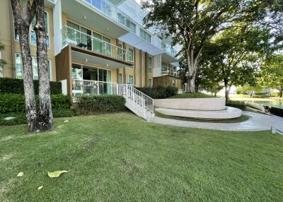 Apartment building with green yard and trees