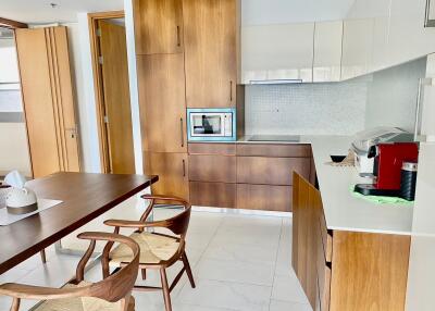 Contemporary kitchen with wooden cabinetry and modern appliances