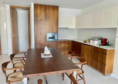 Modern kitchen with wooden cabinets and dining table