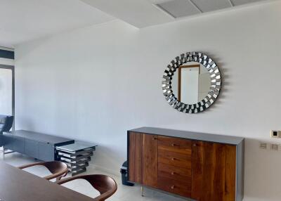 Modern living room area with a mirror and wooden furniture