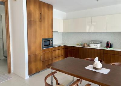 Modern kitchen with wooden cabinets and dining table