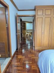 Bedroom with wooden furniture and view of adjacent space