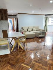 Living room with dining area featuring wooden flooring and modern furniture