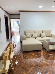 Modern living room with parquet flooring and beige furniture