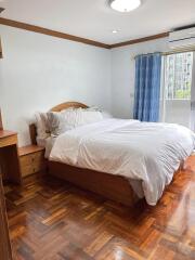 Bedroom with wooden furniture and large bed