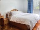 Bedroom with wooden furniture and large bed