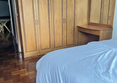 Bedroom with wooden wardrobe and bed