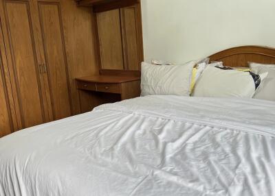 Bedroom with wooden wardrobe and desk