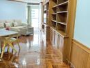 Spacious living room with wooden flooring and built-in shelves