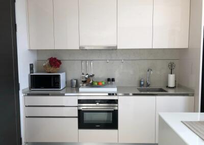 Modern kitchen with white cabinetry and appliances