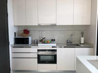 Modern kitchen with white cabinetry and appliances