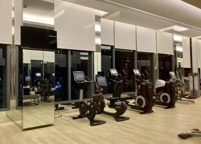 Modern gym with exercise equipment and mirrors