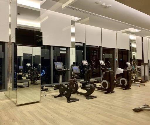 Modern gym with exercise equipment and mirrors