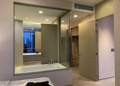 Modern bathroom interior with bathtub and open door