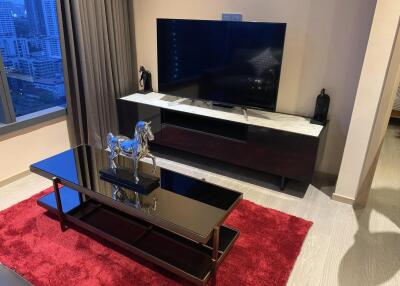 Modern living room with a television, coffee table, and decorative items