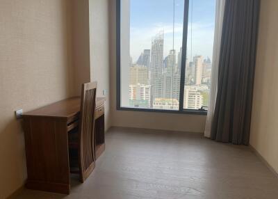 Bedroom with city view and wooden desk