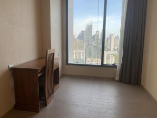 Bedroom with city view and wooden desk