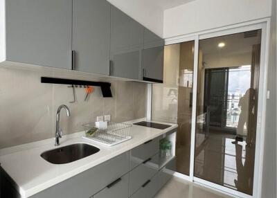 Modern kitchen with grey cabinets and white countertops