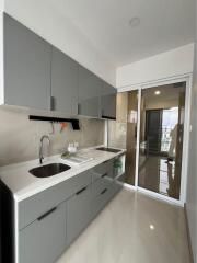 Modern kitchen with grey cabinets and white countertops