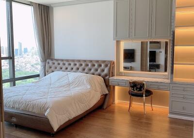 Spacious bedroom with large window and city view