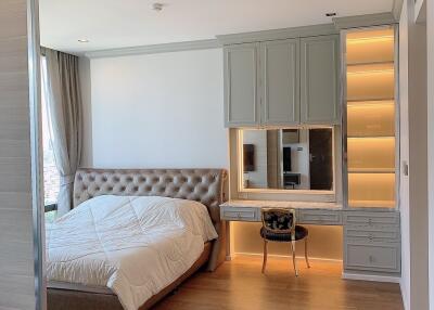 Modern bedroom with bed, built-in vanity and shelves