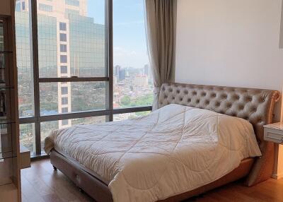 bedroom with large window and city view