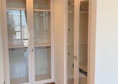 Bright hallway with wooden flooring and glass cabinetry