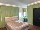 Main bedroom with green paneling and modern furnishings