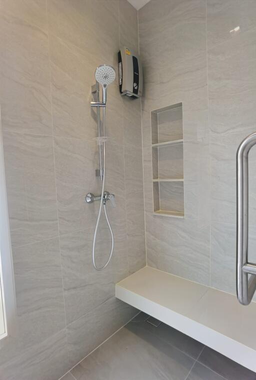 Modern bathroom shower area with built-in shelves