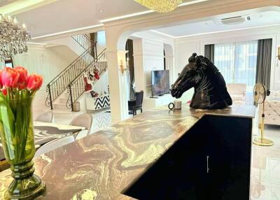 Living room with modern decor including horse head sculpture on the counter.