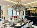 Elegant dining area with chandelier and adjacent living room