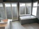 Modern bathroom with large bathtub, dual sinks and shower