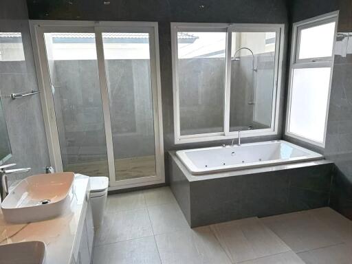 Modern bathroom with large bathtub, dual sinks and shower