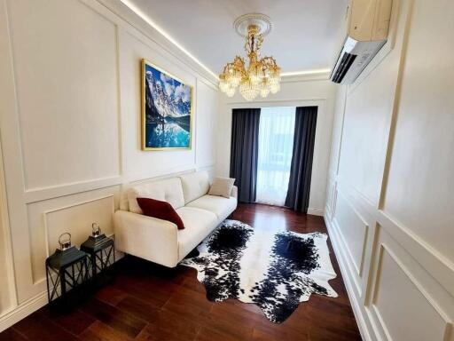 Elegant living room with chandelier and wall art