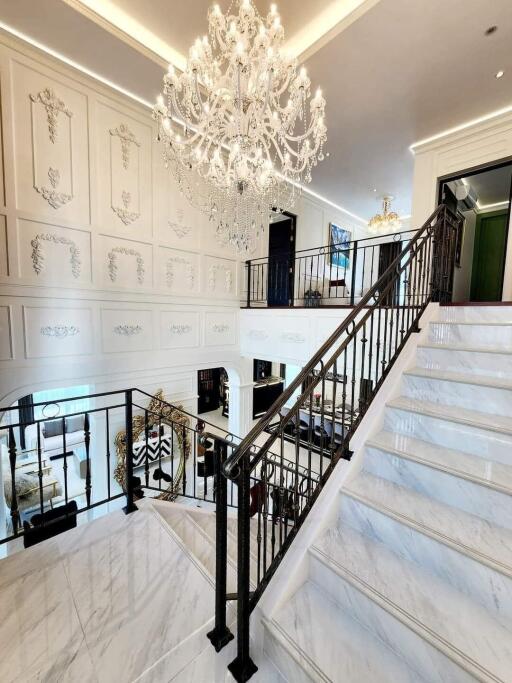 Elegant staircase with chandelier in a luxurious home