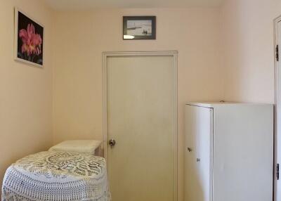 Small room with door, cabinet and wall decorations