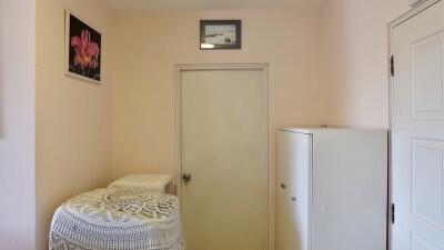 Small room with door, cabinet and wall decorations