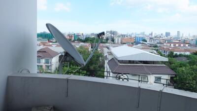 Balcony with city view and satellite dish