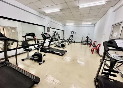 Spacious home gym with various exercise equipment